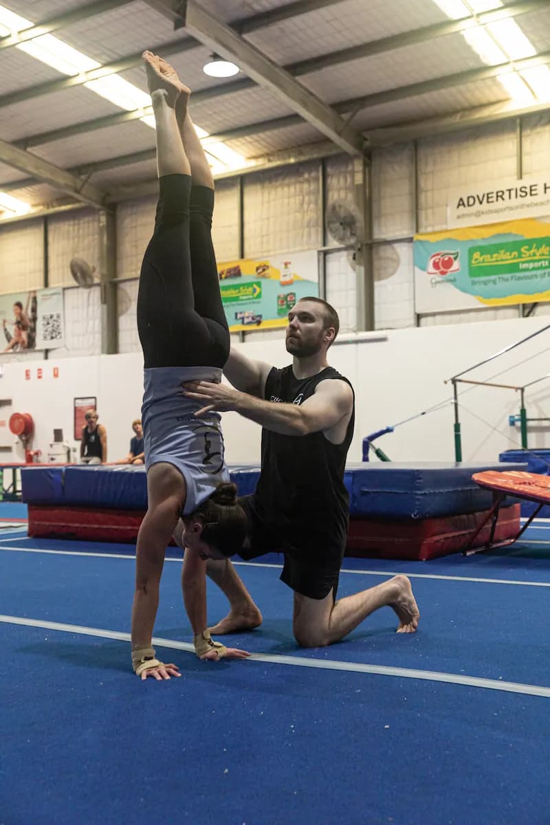 Woman performs a handstand.