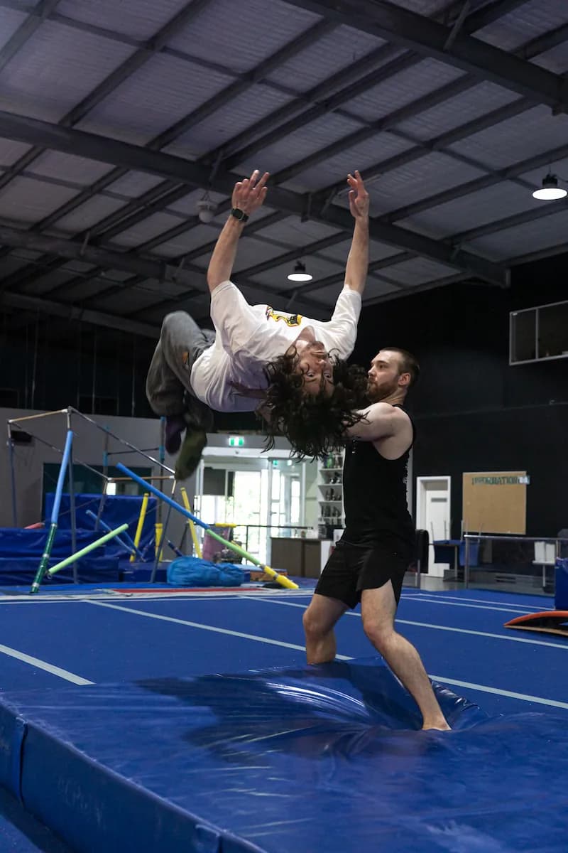 A male perfoms a backflip.